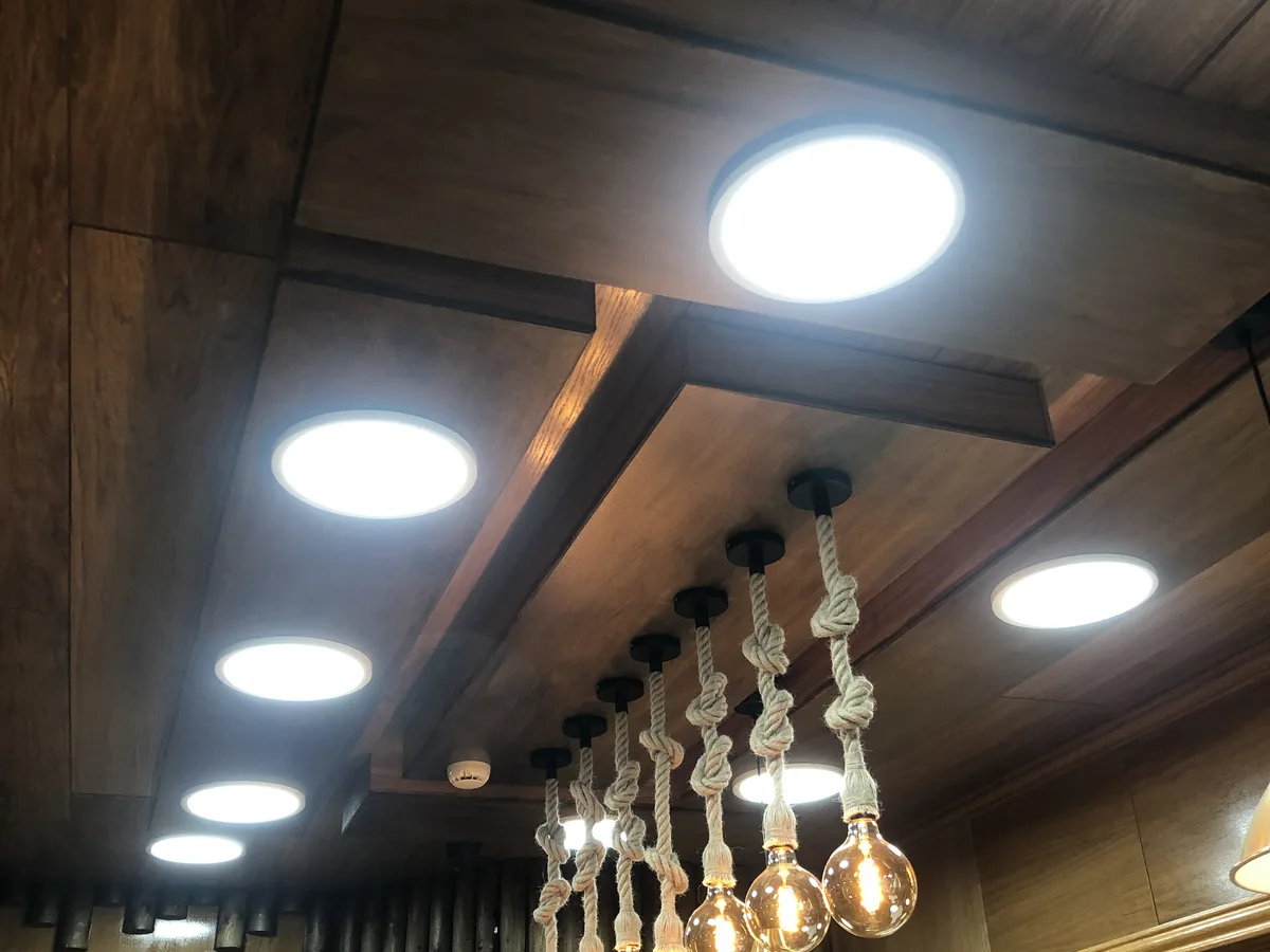 Dark timber ceiling with integrated downlights and rope pendant lights installed in Berkshire