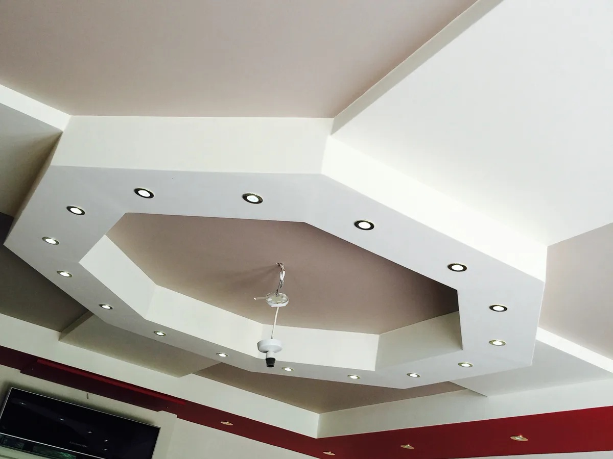 White geometric stepped ceiling with recessed downlights installed in a Berkshire home
