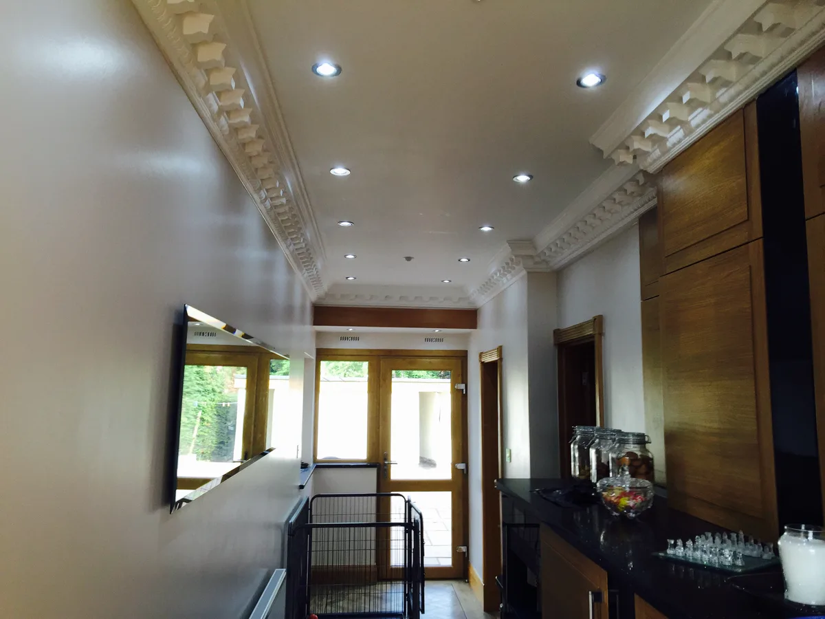 White ceiling with ornate dentil cornice and recessed downlights in a Berkshire home