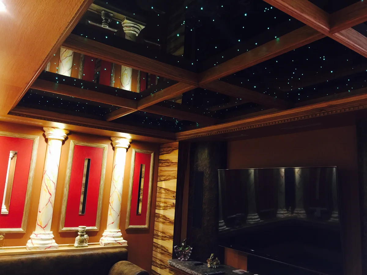 Luxury dark timber coffered ceiling with star LED lighting in a Berkshire home cinema room