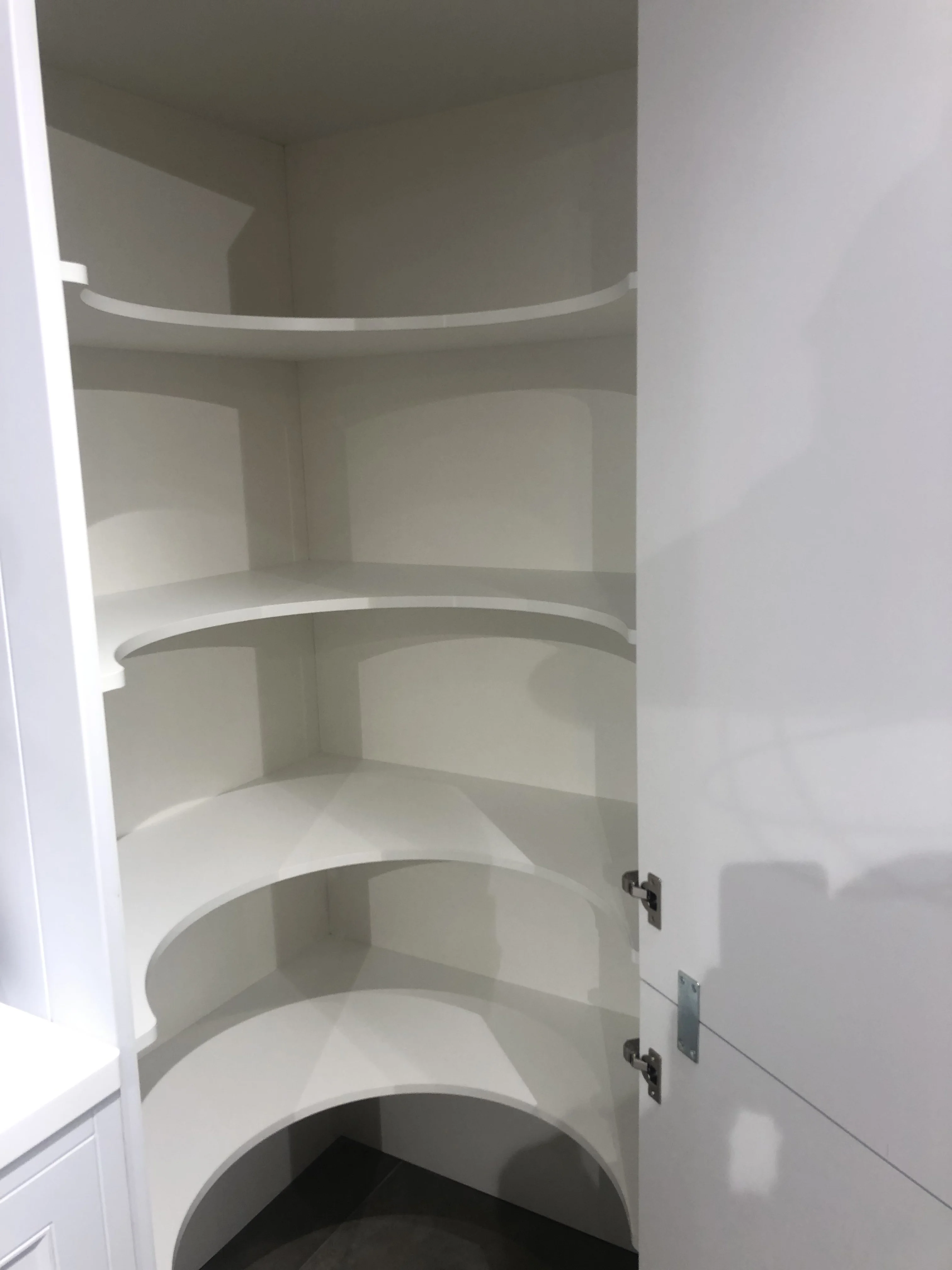 Bespoke curved corner pantry with painted shelving installed in a Berkshire kitchen by Berkshire Bespoke Carpentry