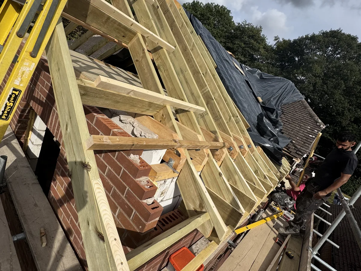 First fix carpentry team laying floor joists on a Bracknell, Berkshire new-build project