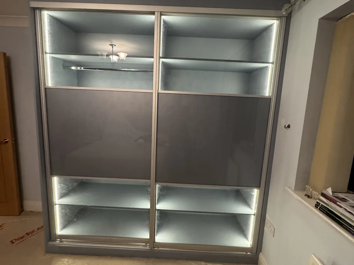 Built-in wardrobes with central TV recess in an Ascot master bedroom