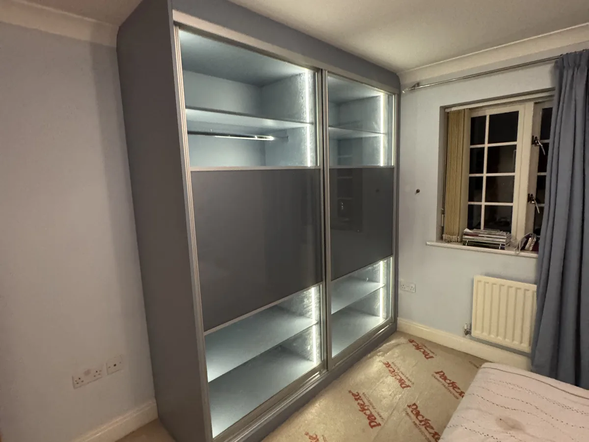 Built-in wardrobes with integrated TV recess in a Bracknell home