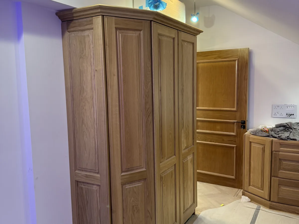 Floor-to-ceiling fitted wardrobes with sliding doors in an Ascot bedroom