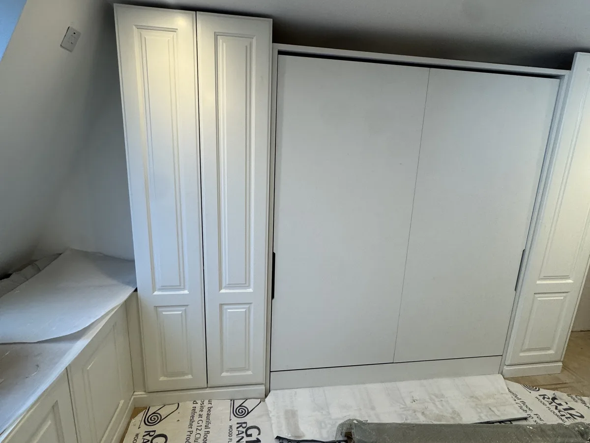 Floor-to-ceiling sliding door wardrobes in a Bracknell master bedroom