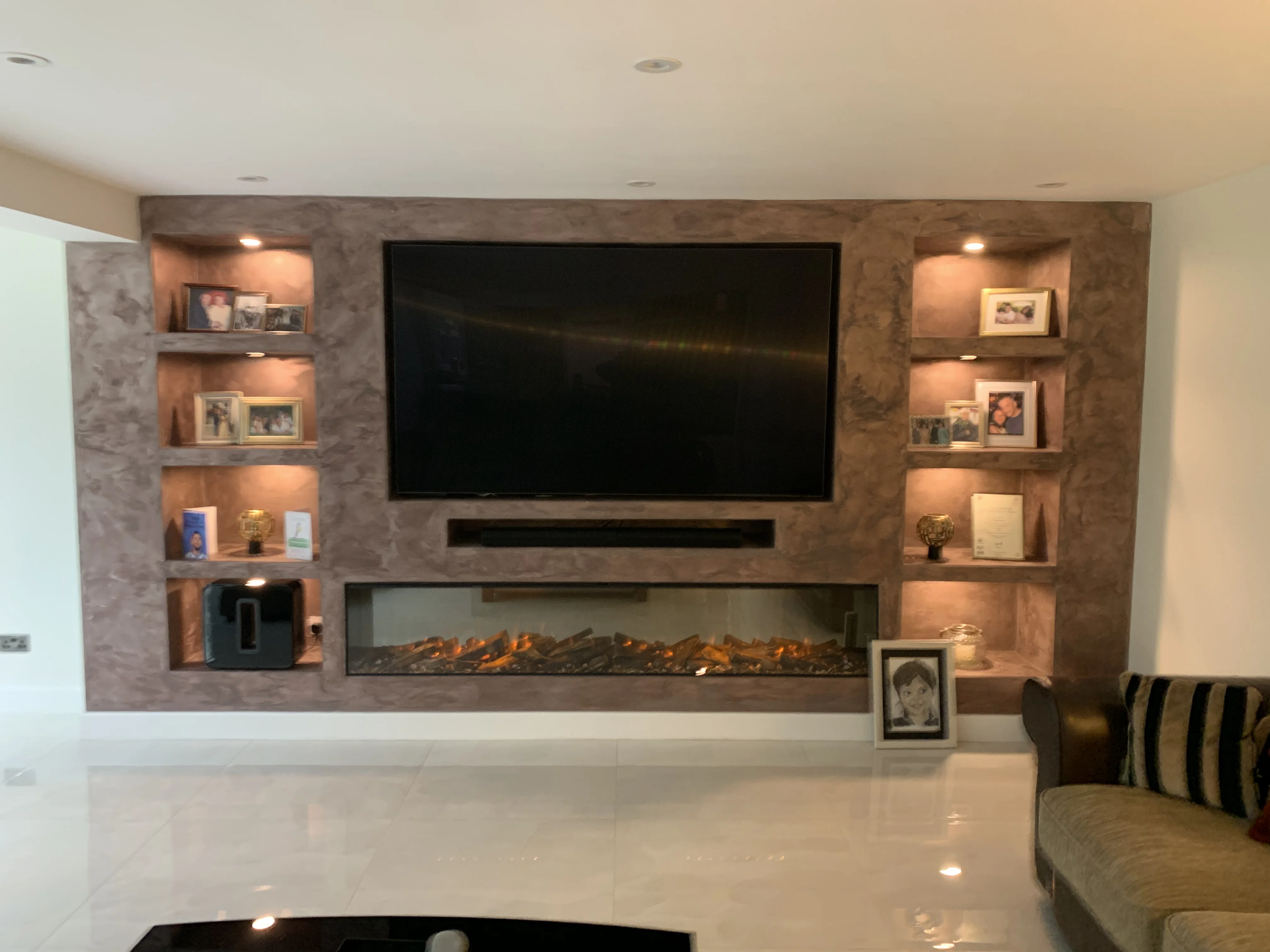 Bespoke media wall with TV alcove and floating shelves in an Ascot, Berkshire living room