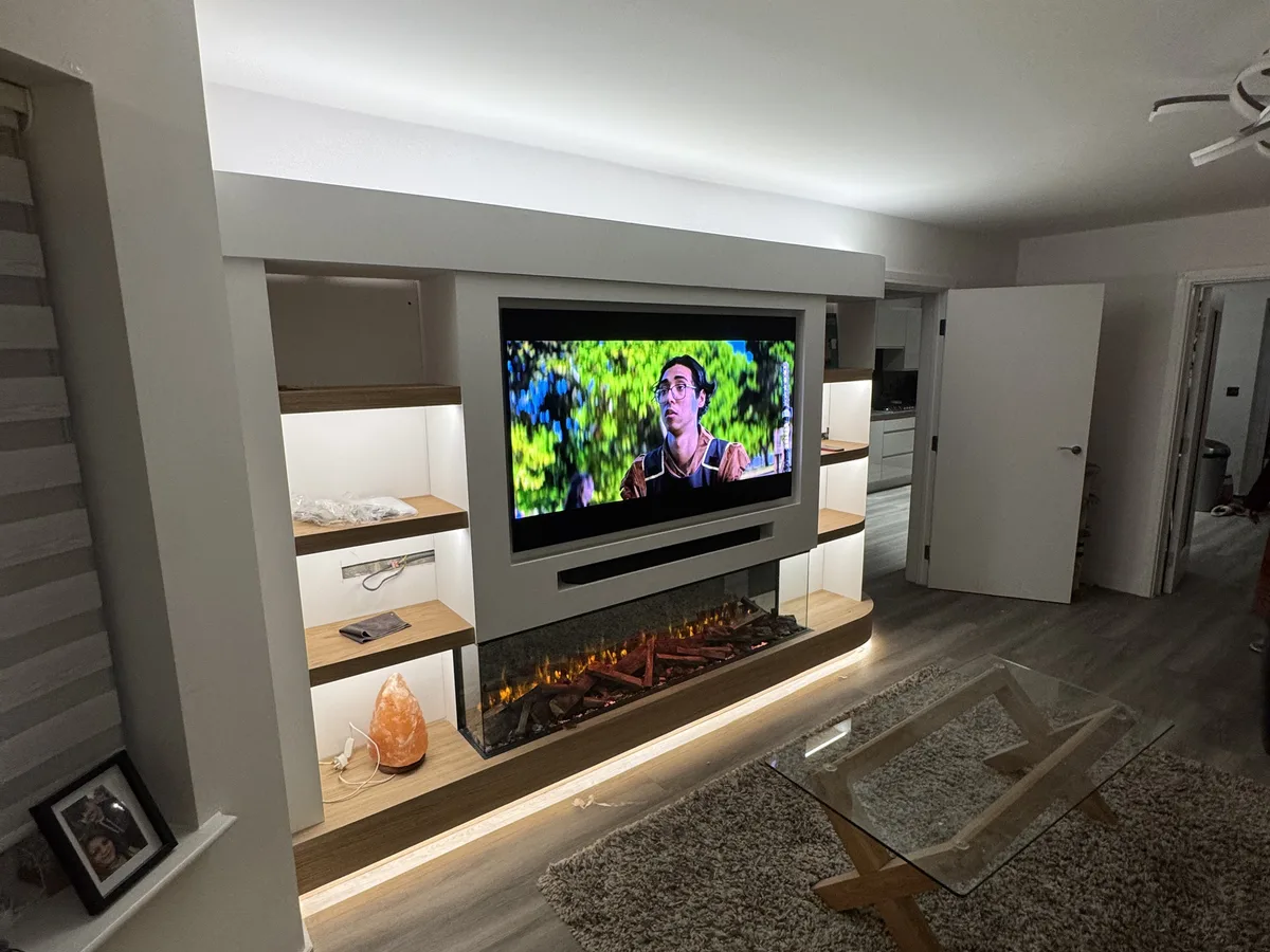Custom media wall with recessed TV niche and floating shelves in Bracknell, Berkshire