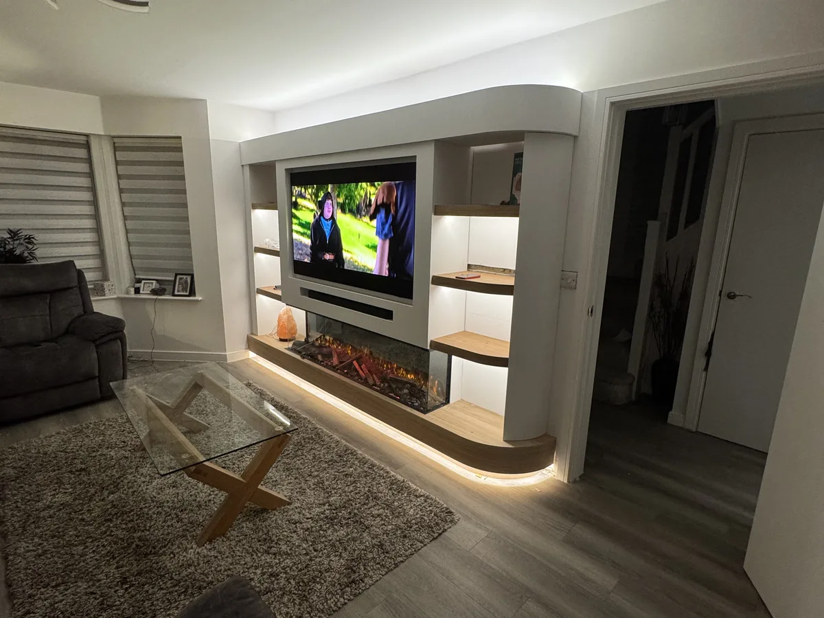 Completed media wall with slatted panels and fireplace in Ascot