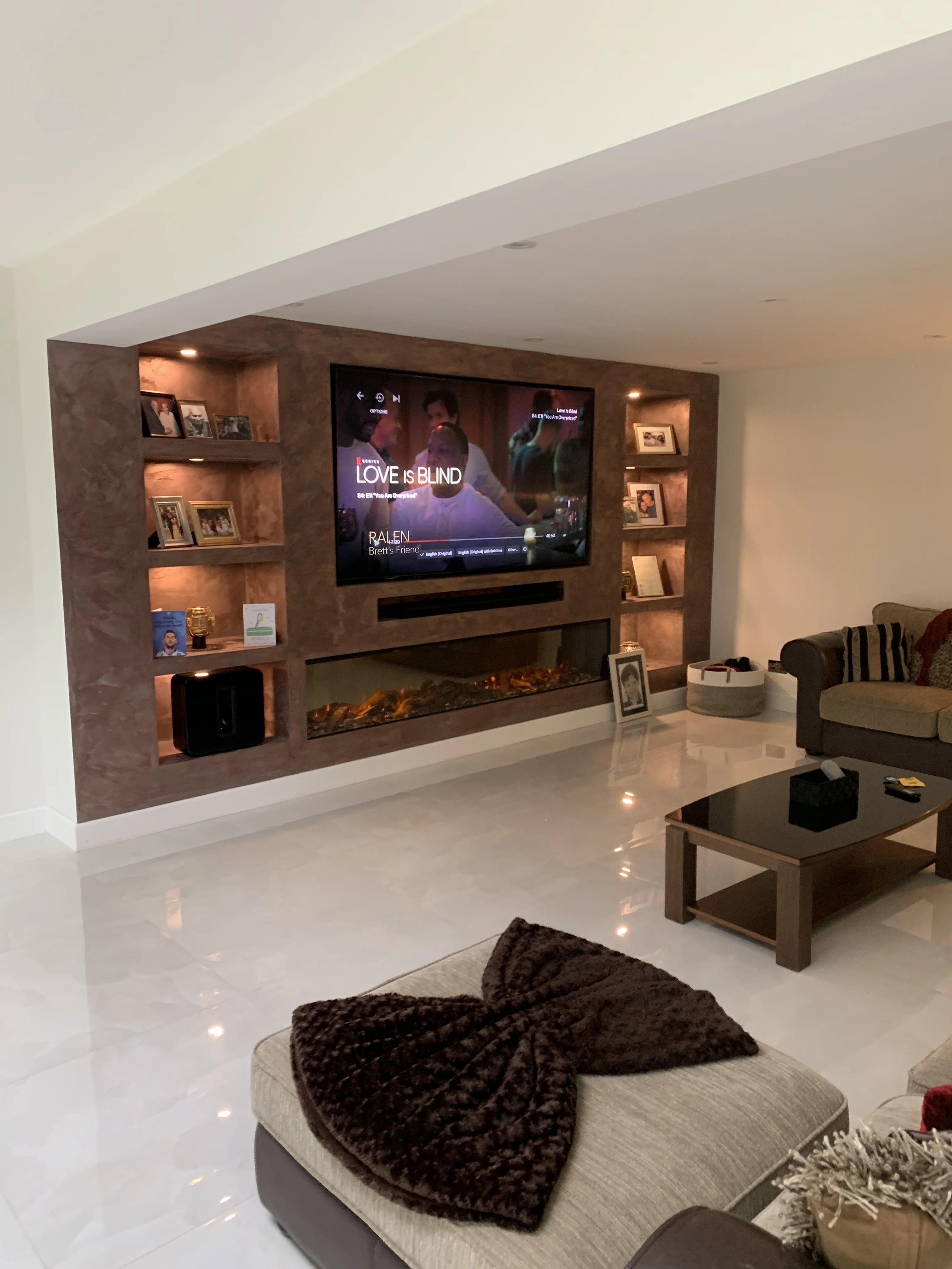 Media wall with LED lighting and slatted timber panels in a Berkshire home
