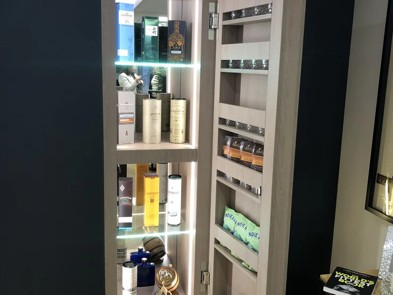 Illuminated bespoke drinks cabinet with sliding door and fitted shelving installed in a Berkshire home