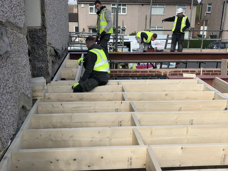 First fix carpentry team laying floor joists on a Berkshire new build and renovation project